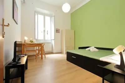 a bedroom with a bed and a table in it at Lucky Home rooms in Rome
