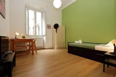a bedroom with a bed and a desk and a table at Lucky Home rooms in Rome