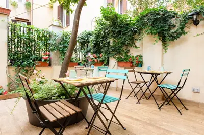 a group of tables and chairs on a patio at Monti Garden in Rome