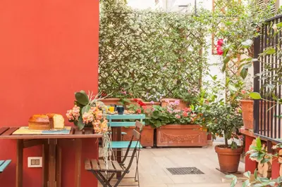 a patio with a table and some plants at Monti Garden in Rome