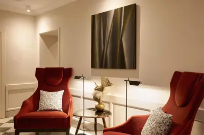 a living room with two chairs and a table at Mascagni Luxury Rooms & Suites in Rome