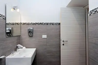 a bathroom with a sink and a mirror at St. Peter Vatican Rooms in Rome