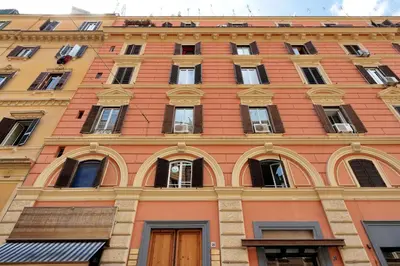 a building with a bunch of windows on it at St. Peter Vatican Rooms in Rome