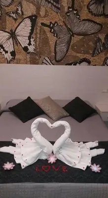 two swans making a heart on a bed at Velvet Suite in Rome