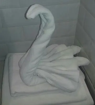 a pile of white towels sitting on top of a bath tub at Velvet Suite in Rome