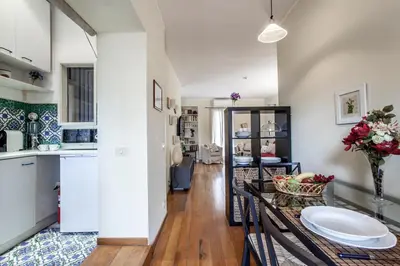 a kitchen and living room with a table and a counter at Domus Colosseum in Rome