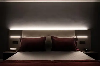 a bedroom with a bed with two red pillows at Hotel Varese in Rome