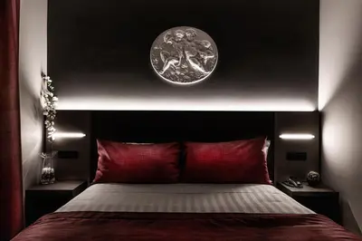 a bedroom with a bed with a clock on the wall at Hotel Varese in Rome