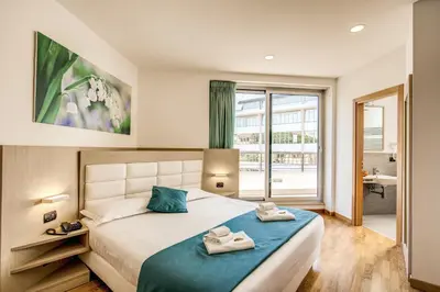 a bedroom with a bed with two towels on it at Ginevra Palace Hotel in Rome