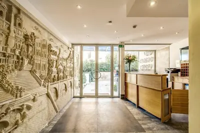 a hallway with a wall mural of a staircase at Ginevra Palace Hotel in Rome
