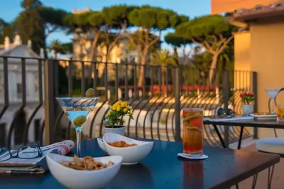 a table with bowls of food and a drink at Hotel Degli Artisti in Rome