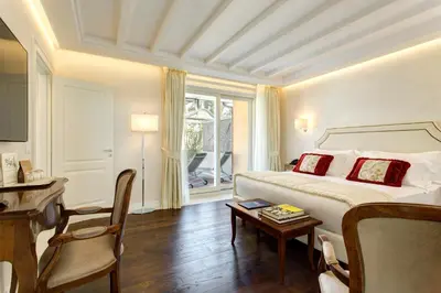 a hotel room with a bed and a table and a chair at Hotel Degli Artisti in Rome