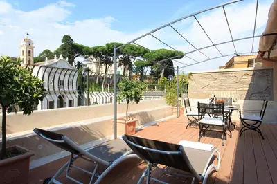 a patio with chairs and a table on a balcony at Hotel Degli Artisti in Rome