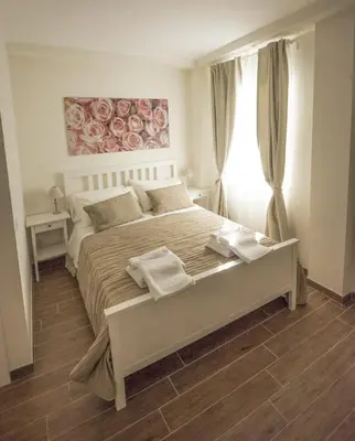 a white bedroom with a large bed in a room at BePlace Aventino in Rome