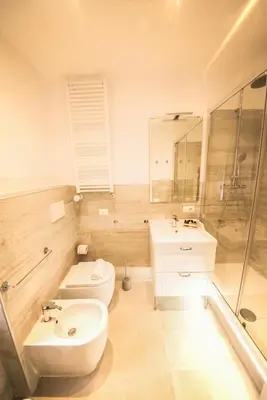 a bathroom with a toilet and a sink at BePlace Aventino in Rome
