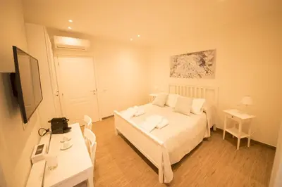 a bedroom with a bed and a table and a television at BePlace Aventino in Rome