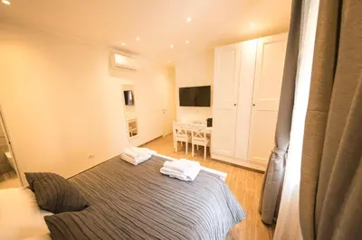a bedroom with a bed and a dining room at BePlace Aventino in Rome