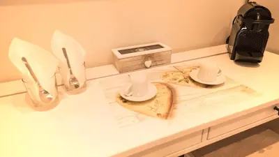 a table with two dishes and a clock on it at BePlace Aventino in Rome