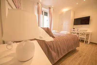 a bedroom with a bed and a table with a lamp at BePlace Aventino in Rome