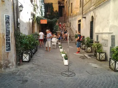 a group of people standing in an alley with people standing around at Olimpica Relais guest house in Rome