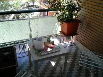 a table on a balcony with a tea pot on it at Olimpica Relais guest house in Rome