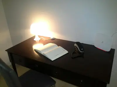 a desk with a lamp and an open book at Olimpica Relais guest house in Rome