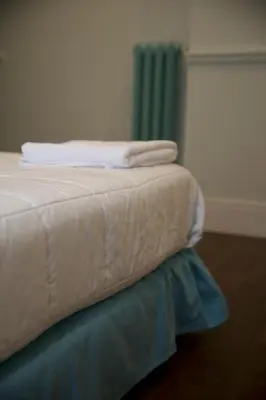 a close up of the corner of a bed at Relais della Torre in Rome