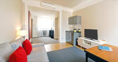 a living room with a couch and a table and a television at Adamas Luxury Suite in Rome