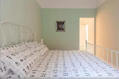 a bedroom with a bed with a white bedspread at Exclusive apartment a few steps from the Spanish Steps in Rome