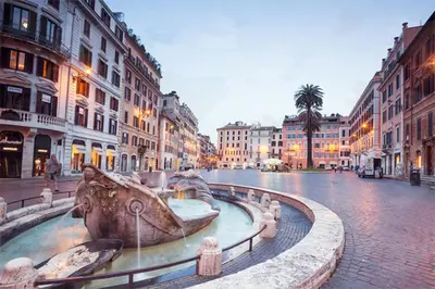 a large fountain in the middle of a city street at Exclusive apartment a few steps from the Spanish Steps in Rome