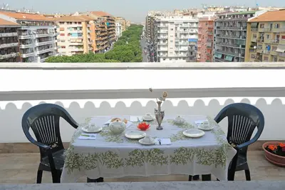 a table with a white table cloth on a balcony at Attico luminoso terrazza Metro A Aria Cond WiFi in Rome