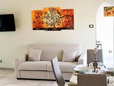a living room with a couch and a painting on the wall at Attico luminoso terrazza Metro A Aria Cond WiFi in Rome