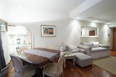 a living room with a table and a couch at Holidays Banchi Nuovi in Rome