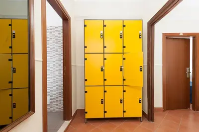 a row of yellow lockers in a locker room at Budget Rooms Des Arts in Rome
