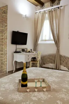 a bottle of wine and two glasses on a table at Navona Sweet Home in Rome