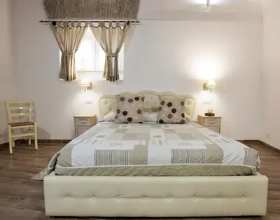 a bedroom with a white bed and a chair at Navona Sweet Home in Rome