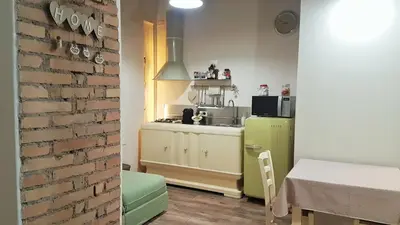 a kitchen with a green refrigerator and a table at Navona Sweet Home in Rome
