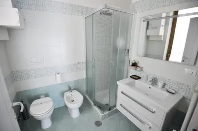 a bathroom with a toilet and a sink and a shower at Le Fontane di Roma in Rome