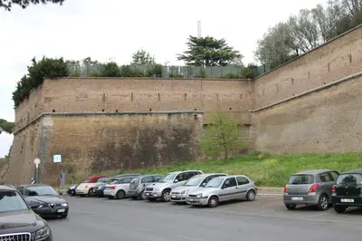 a row of cars parked next to a large wall at Le Fontane di Roma in Rome
