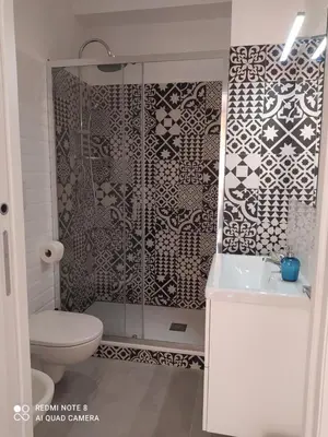 a bathroom with a shower with a toilet and a sink at Flaminio Holidays in Rome