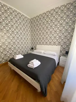 a bedroom with a bed with towels on it at Flaminio Holidays in Rome