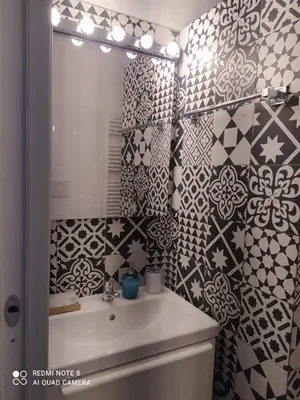 a bathroom with a sink and a mirror at Flaminio Holidays in Rome