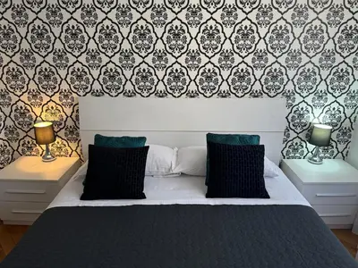 a bedroom with a bed and two nightstands with lamps at Flaminio Holidays in Rome