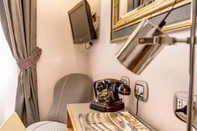a telephone sitting on a table in a room at Parlamento Boutique Hotel in Rome