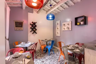 a dining room with two tables and chairs at Parlamento Boutique Hotel in Rome