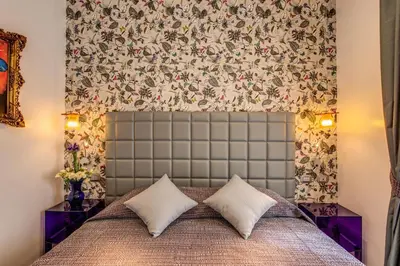 a bedroom with a bed with two pillows at Parlamento Boutique Hotel in Rome