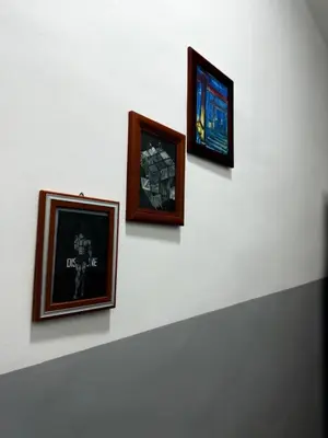 a group of three pictures on a wall at Vertex Suite in Rome
