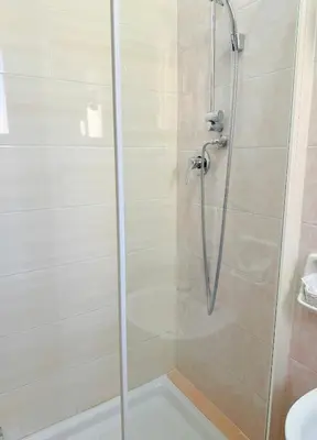 a shower with a glass door in a bathroom at Vertex Suite in Rome