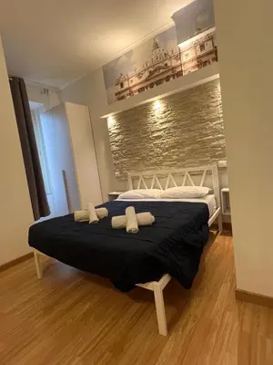 a bedroom with a bed with two towels on it at Rooma Beb in Rome
