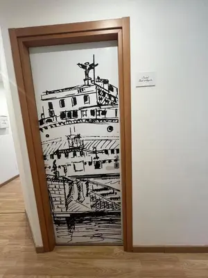 a door with a drawing of a ship at Rooma Beb in Rome